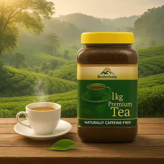 1kg Brahmkalp Premium Organic Tea jar placed on a wooden table with a steaming tea cup in front of lush green tea plantations and misty hills in the background, representing natural and caffeine-free wellness